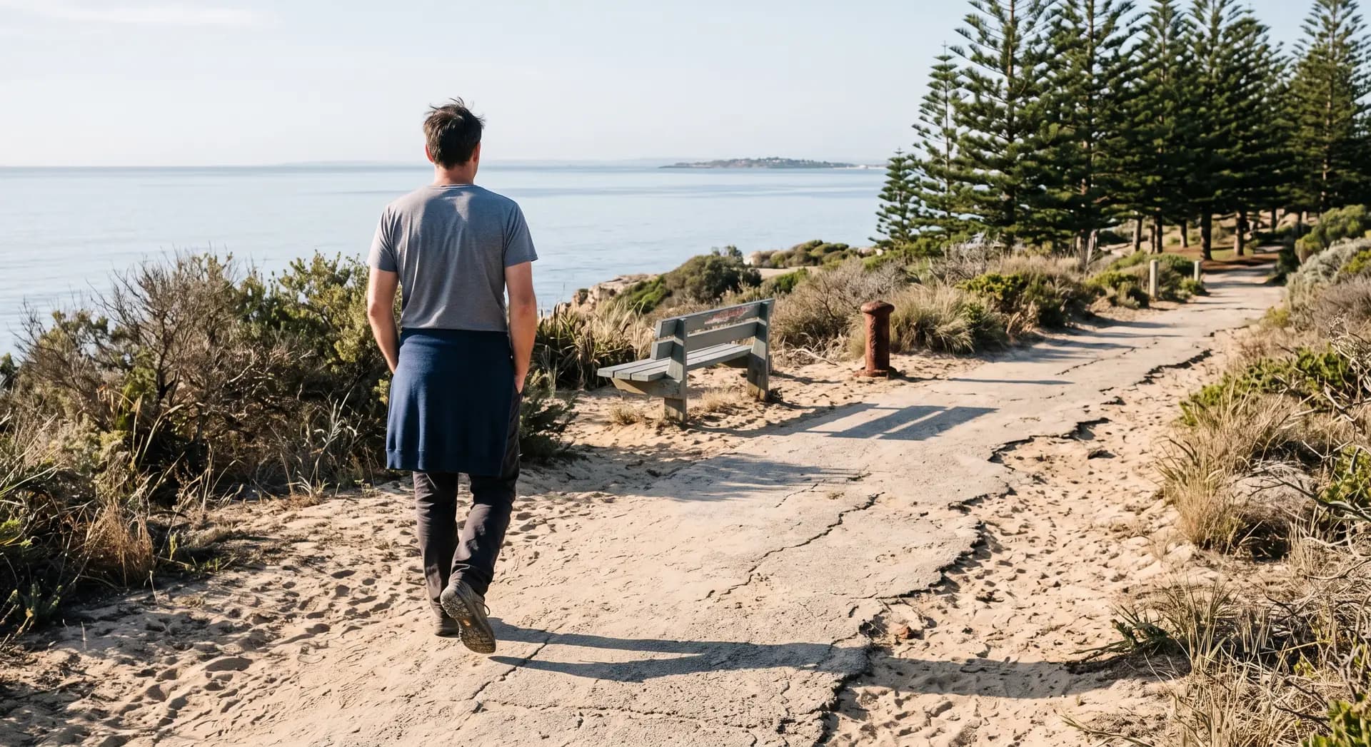A person walking a coastal path near Fremantle in the morning